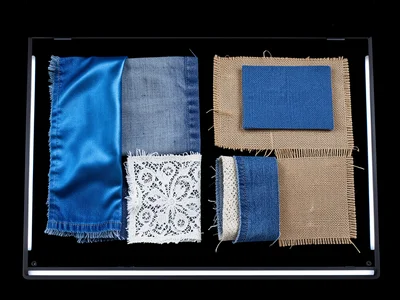 Fabric scraps arranged on scanner, different textiles: silk, denim, lace, burlap