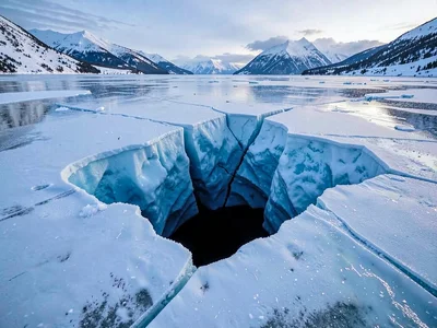 Deep crack disappearing into blue-black depth