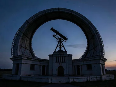 Telescope pier silhouette visible through open dome