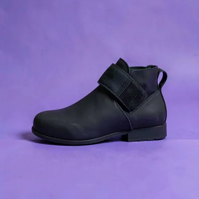single matte-black ankle-weight strap with a velcro band straight-on against a s