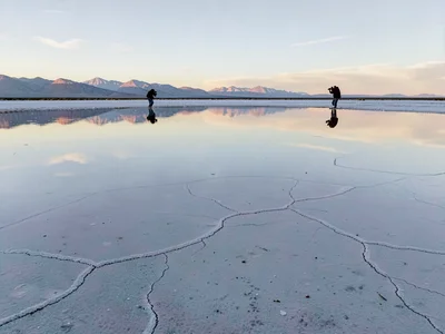 Photographer capturing reflection becoming part of it