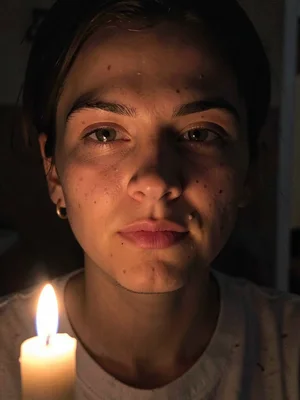 Face lit by single candle