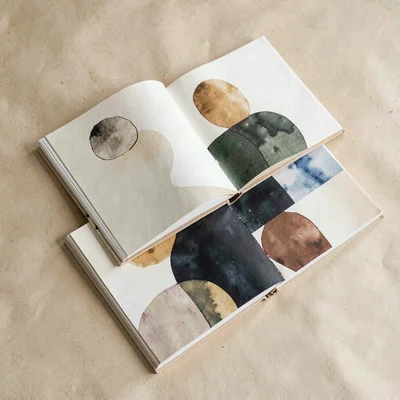 An illustration-portfolio printed-zine mockup with three zines stacked at varyin