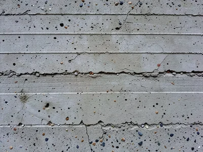 Board-formed concrete wall, wood grain texture transferred perfectly into grey c