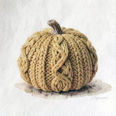 Squashy mustard knit pumpkin gourd with chunky cable ridges and a tiny felted st