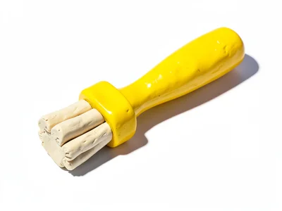Hardworking chunky clay paintbrush in primary yellow with stubby cream-toned bri