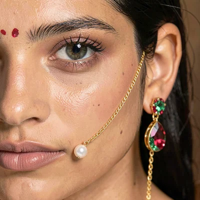 Through the Jaipur gem cutter's eye, faceted light, A nose ring with a single pe
