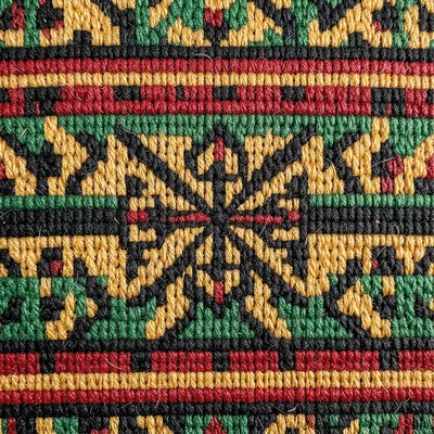 Kente pattern detail — single adinkra-inspired motif block, close-up macro