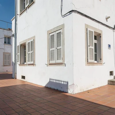 Siesta stillness, afternoon heat weight, Shuttered windows on a whitewashed wall