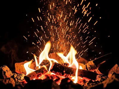 Ember dust rising as orange sparks