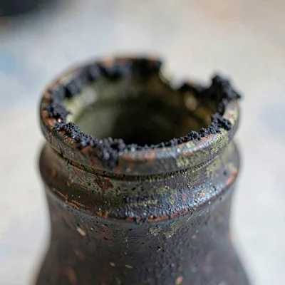 Macro of an oxidized inkwell with dried ink crust along the rim