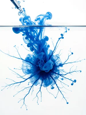 Ink spreading on wet paper in notebook blue, pen refill burst
