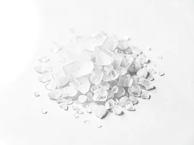 Salt crystals on white surface