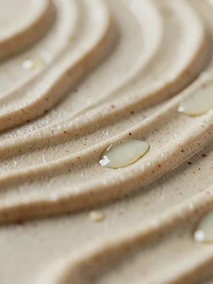 Hand-built coil joins beneath a wash of pale shino, gentle ridges marching like