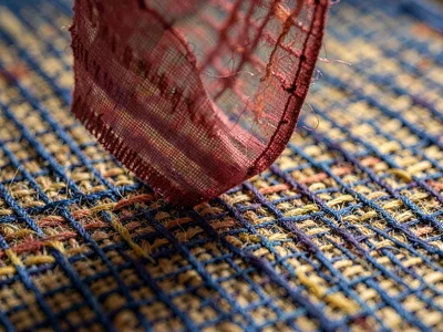 Gauze of hemp dyed cochineal-rose hovers translucent above hair-thin shadow with