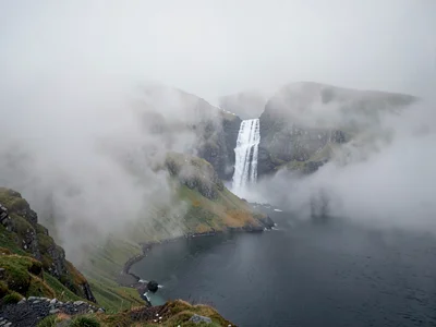 Waterfall visible through mist as white line