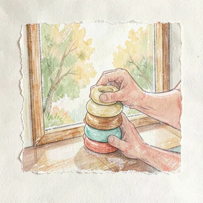 Small hands stacking wooden rings on a sunny windowsill, paper-soft palette