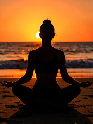 Person in lotus position on beach at sunrise, entire form defined only by edge l