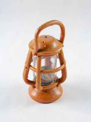 Caged ochre cricket lantern with a slumped handle and fingernail dents along the