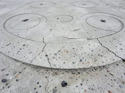 Tadao Ando signature concrete, perfectly smooth with circular form-tie patterns 