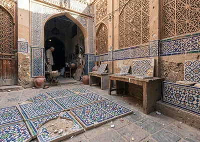 Geometric shadow play in Marrakech medina, ceramic workshop with unfinished zell