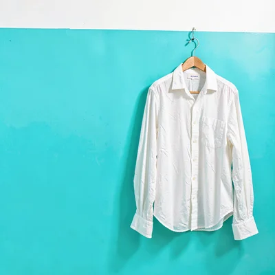 Expansive turquoise negative space, bleached whites, White linen shirt hanging o