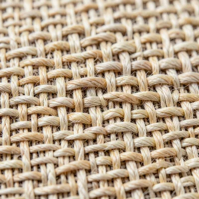 Linen plain weave extreme closeup, natural ecru flax fibers crossing at right an
