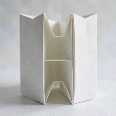 Vertical macro of a paper accordion file divided into five compartments