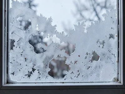 Breathing hole in morning window frost