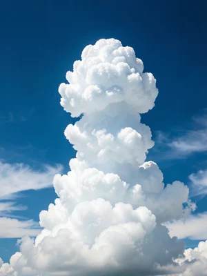 Towering cumulus congestus — single vertical cloud column rising with cauliflowe