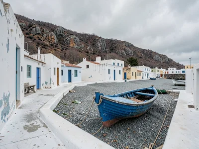 Blue Boat Pulled Up on Winter Pebbles
