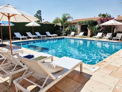 Swimming pool with loungers