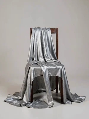 Empty chair with mourning dress draped over it as if the body simply evaporated,