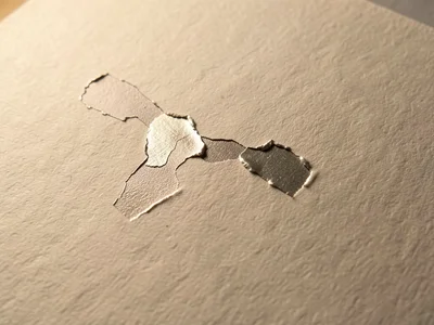 Foil pull defect, metallic layer partially transferred leaving torn foil creatin