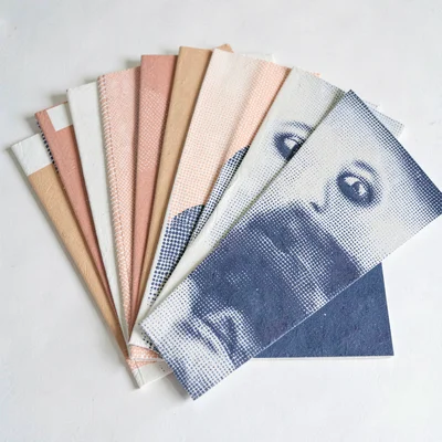 Two-color riso program-cover motif of stacked halftone catalogue pages fanning o