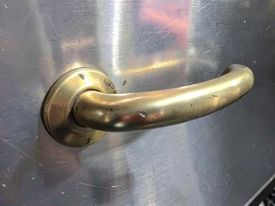 Brass door handle worn smooth