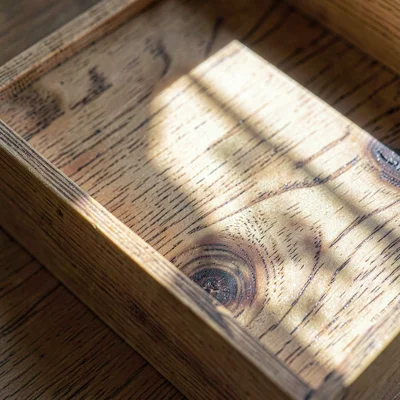 Tight texture study of cedar humidor lining with grain swirl, raking light acros