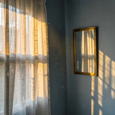 Brass mirror reflecting morning amber shaft