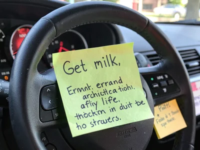 Sticky note on steering wheel: "Get milk," the errand architecture of daily life