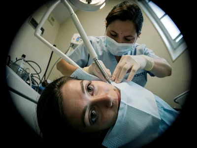 Dentist approaching with tools, patient's eye view, everything tilted wrong
