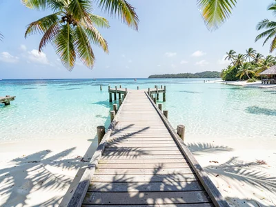 Lagoon turquoise light in Rarotonga, A wooden pier extending into still turquois