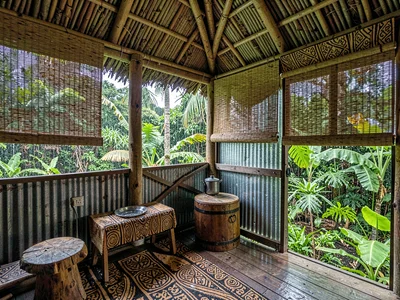 Open-air fale life in Samoa after rain, Woven blinds rolled up on a fale, inside