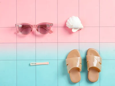 Sparse four-object grid of plastic sunglasses, hair clip, jelly sandal, and a sm