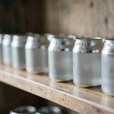 Macro of a wooden shelf with rows of frosted pints, soft natural light