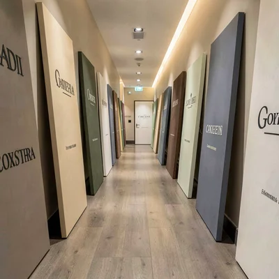 Vertical hallway lined with leaning brand panels, each a different muted tonal b