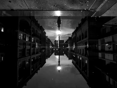 Street lamp creating pool of light reflections
