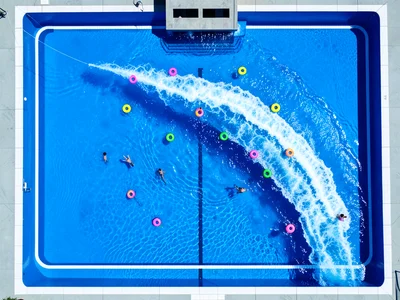 A wave pool at a water park from above at the moment of a wave, the wavefront vi