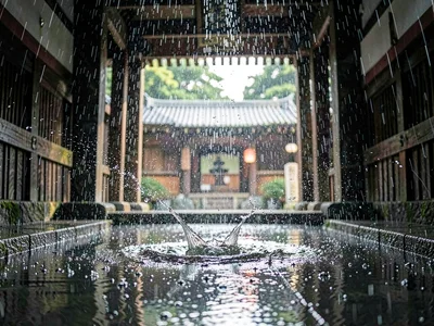 Rain through temple gateway catching light