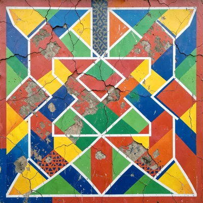 Section of painted plaster — cracked surface revealing layers of older pattern b
