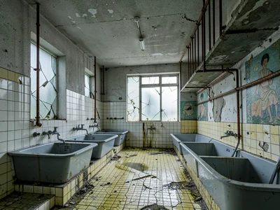 Hydrotherapy Room with Rusted Pipes and Cracked Tile